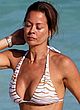Brooke Burke naked pics - sunbathes in bikini on a beach