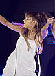Ariana Grande performs on a stage pics