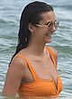 Nina Dobrev shows ass in orange swimsuit pics