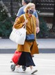 Naomi Watts looks stylish in a yellow coat pics