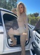 Khloe Kardashian posing in beige catsuit pics