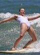 Margot Robbie surfing in white swimsuit pics