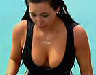 Kim Kardashian shows cleavage in wet bikini clips